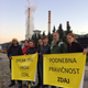 The crew stands before a coal plant in Velenje, Slovenia.